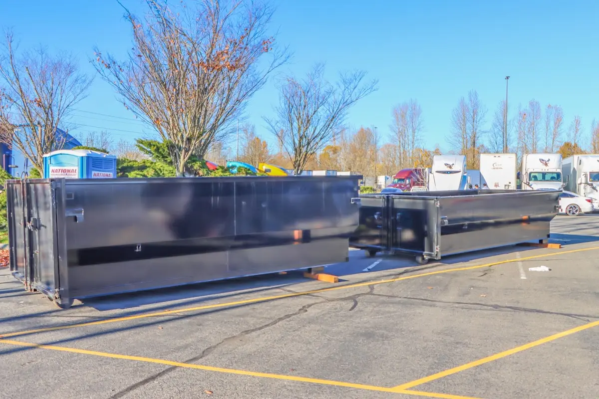 Professional dumpster rental service with roll-off container on residential driveway in South Londonderry